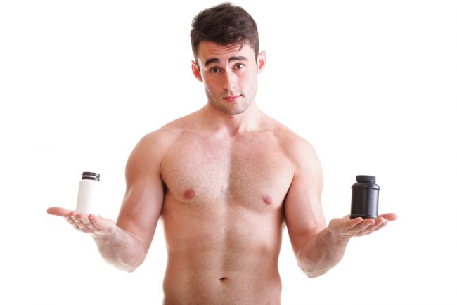 man holding supplement pill bottles