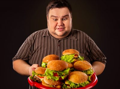 fat man plateful of burgers