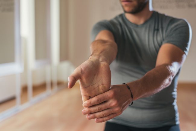 Man stretching his forearm